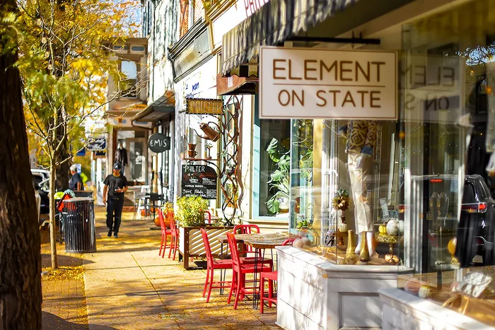 Charming street scene with boutique stores and vibrant outdoor seating.