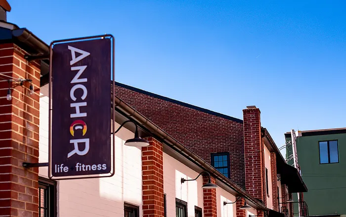 Exterior view of Anchor fitness center, showcasing modern brick architecture and elegant design.