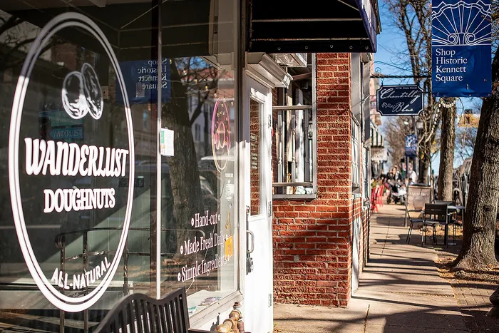 Exterior view of Wanderlust Doughnuts with inviting storefront windows on a sunny street.