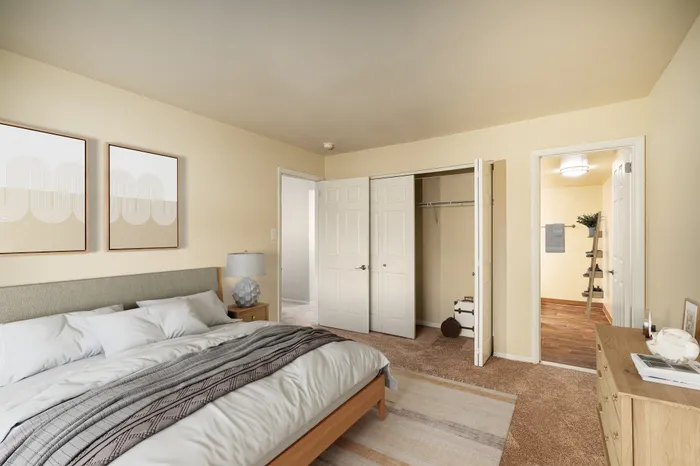 Inviting bedroom with a plush bed, soft lighting, and spacious closet.