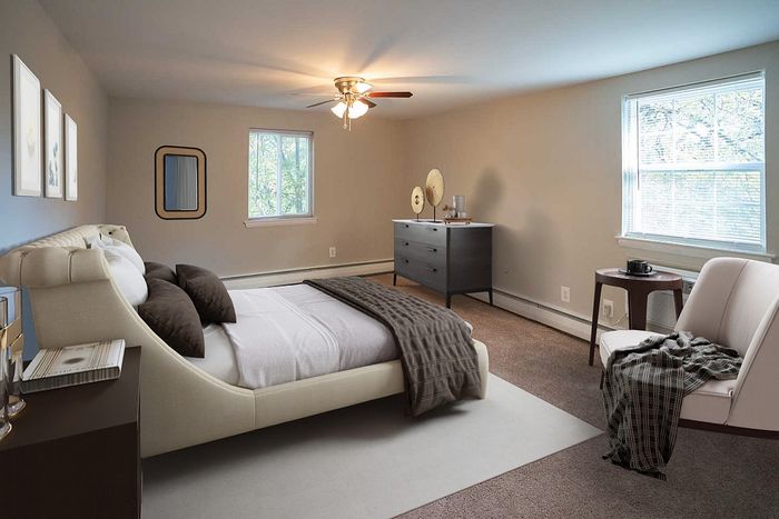 Luxurious bedroom featuring a plush bed, stylish decor, and ample natural light.