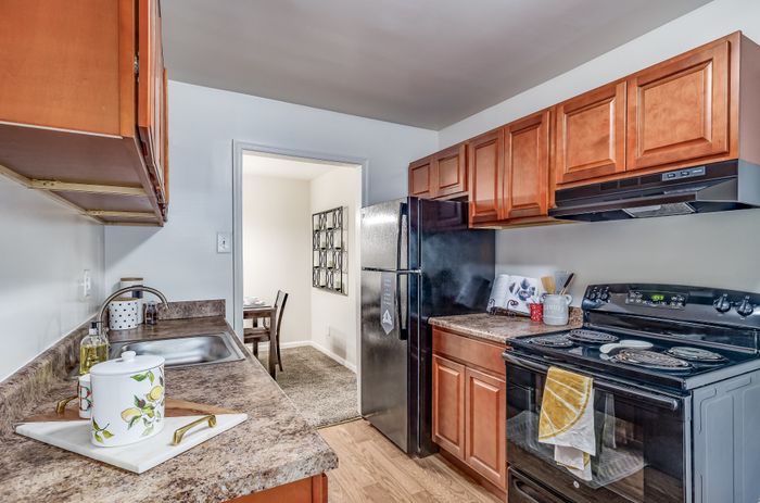 Inviting kitchen with warm wood cabinetry, modern appliances, and a cozy dining area.
