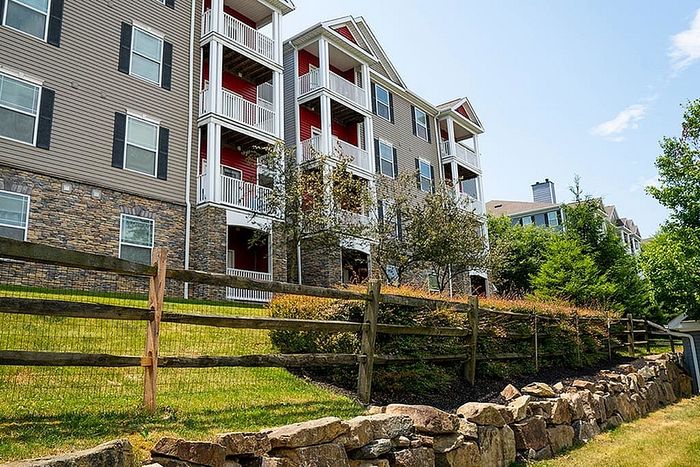 Picturesque apartment building with modern design and lush greenery.