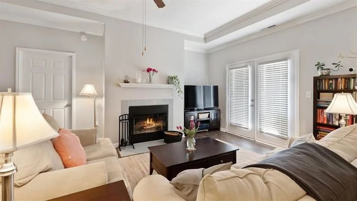 inviting living room with vinyl hardwood floors, fireplace and french doors