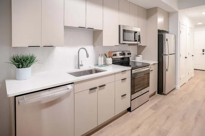 Modern kitchen with sleek cabinetry, stainless steel appliances, and elegant countertops, perfect for culinary creativity.