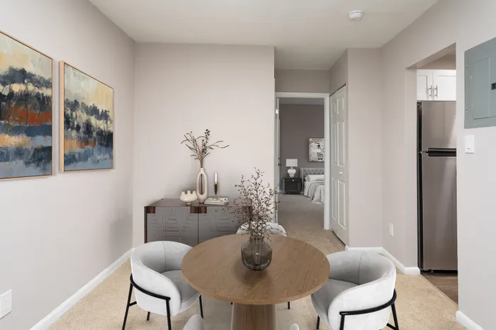 Inviting apartment interior with a cozy dining area and elegant chairs.