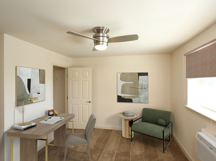 Chic home office with modern desk, stylish artwork, and cozy seating creating an inviting workspace atmosphere.