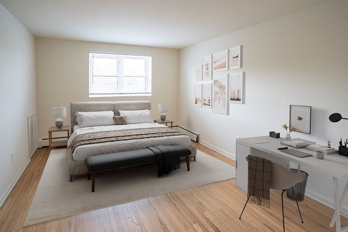 Inviting bedroom with a cozy bed, stylish decor, natural light from a large window, and a functional desk space.