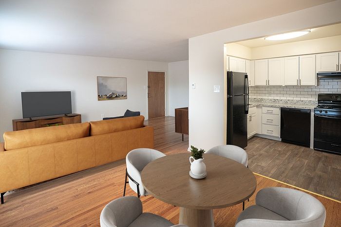 Inviting apartment with open-concept living room, cozy dining area, and sleek kitchen featuring modern appliances.