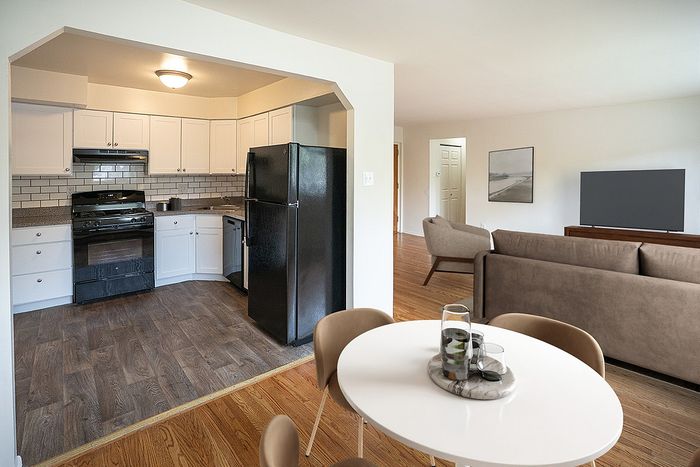 Chic open-concept apartment featuring a modern kitchen, stylish living room, and elegant dining area.