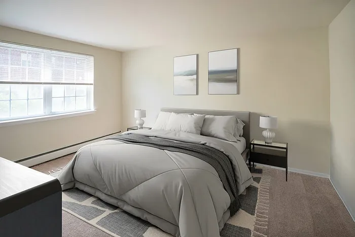 Bright and inviting bedroom with a plush queen-size bed, modern decor, and large window allowing natural light to flood the room.