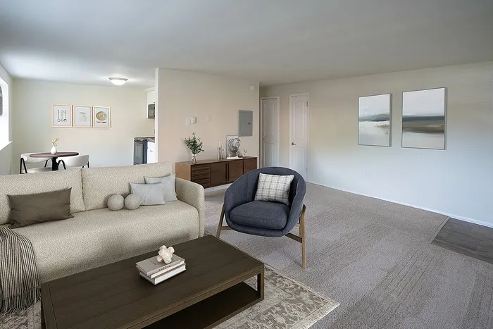 Contemporary open-concept living room with cozy seating, elegant decor, and a warm, inviting dining area.