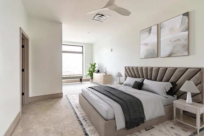 Elegant bedroom with plush bed, cozy rug, and modern decor featuring a soothing color palette and natural light.