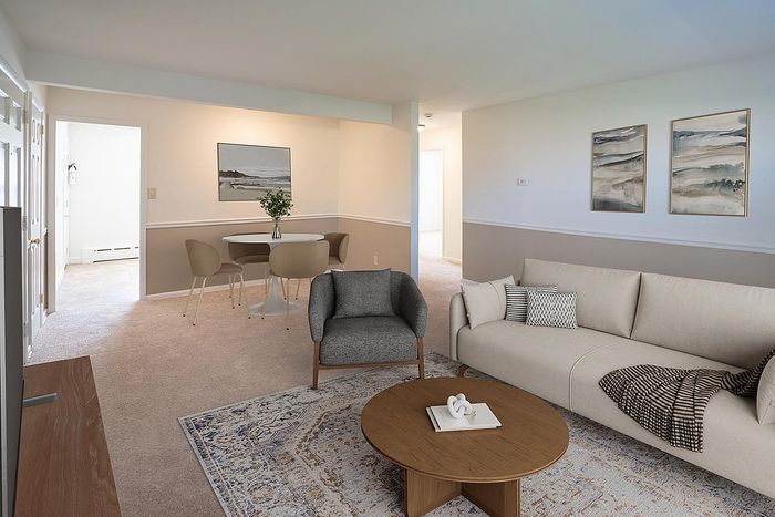Inviting open-concept living room with elegant decor, plush seating, and stylish dining area perfect for entertaining.