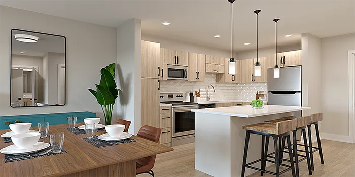 Modern open-plan kitchen and dining area with sleek appliances, stylish island with pendant lighting, and inviting dining table setup.