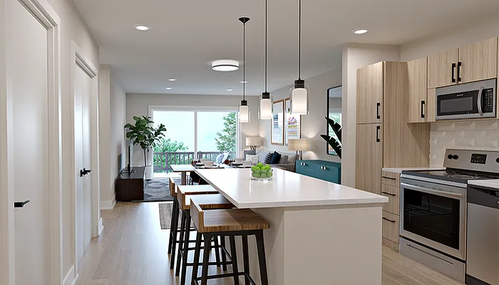 Modern kitchen with sleek countertops, pendant lighting, and open living area leading to a scenic balcony view.
