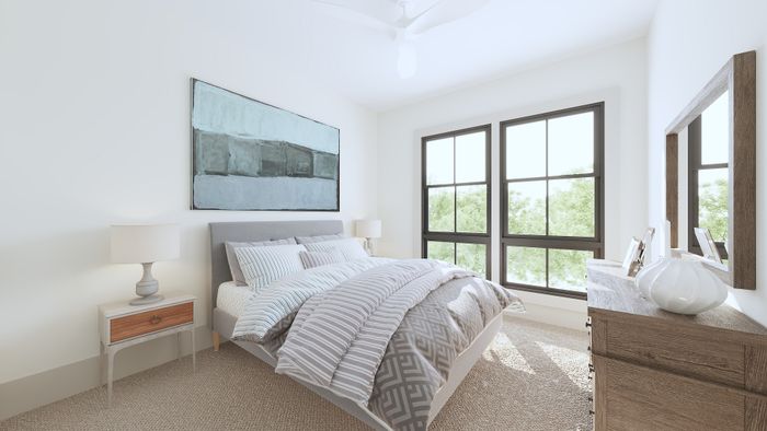 Bright, serene bedroom with a large window, elegant decor, and plush bedding inviting relaxation.