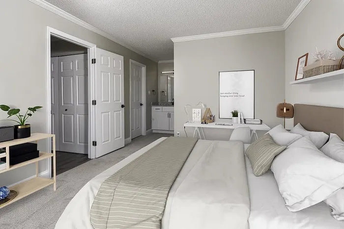 Inviting bedroom with a plush bed, minimalist decor, and soft neutral tones offering a cozy and serene atmosphere.