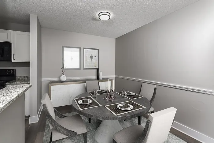 Elegant dining area with a modern round table, plush chairs, and a backdrop of sleek contemporary decor.