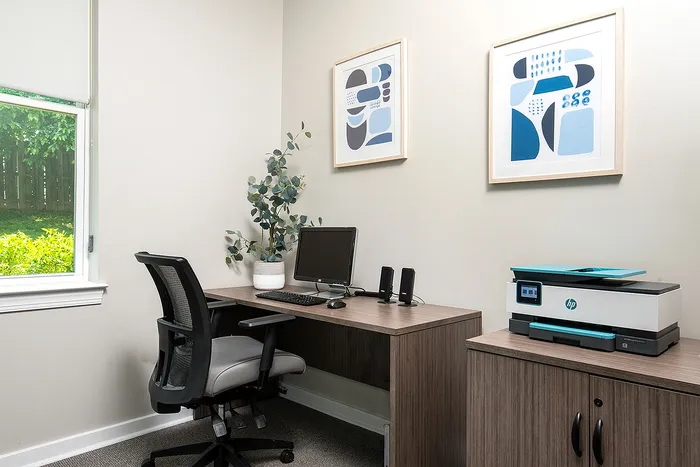 Bright home office with a large window, modern desk, ergonomic chair, and stylish decor, perfect for productivity and comfort.