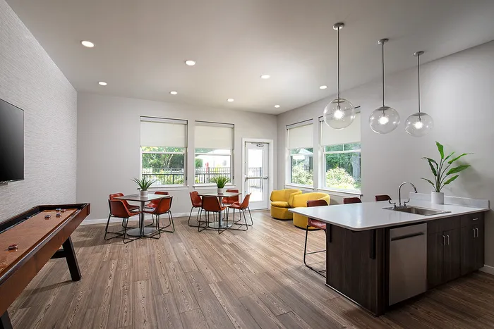 Modern open-concept living space featuring stylish seating, abundant natural light, and a sleek kitchen island, ideal for entertaining.