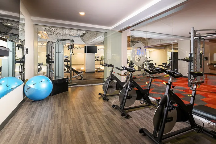 Modern fitness center with sleek exercise bikes, state-of-the-art equipment, and vibrant design elements, perfect for an invigorating workout.