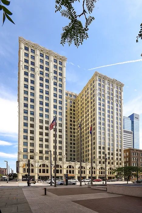 Stunning high-rise building with classic architecture and a vibrant urban setting, perfect for modern city living.