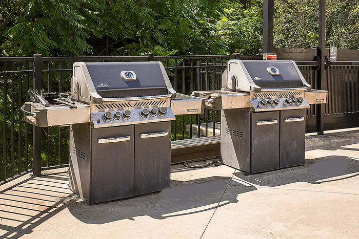 Inviting outdoor grilling area featuring dual stainless steel barbecue grills, perfect for summer gatherings.