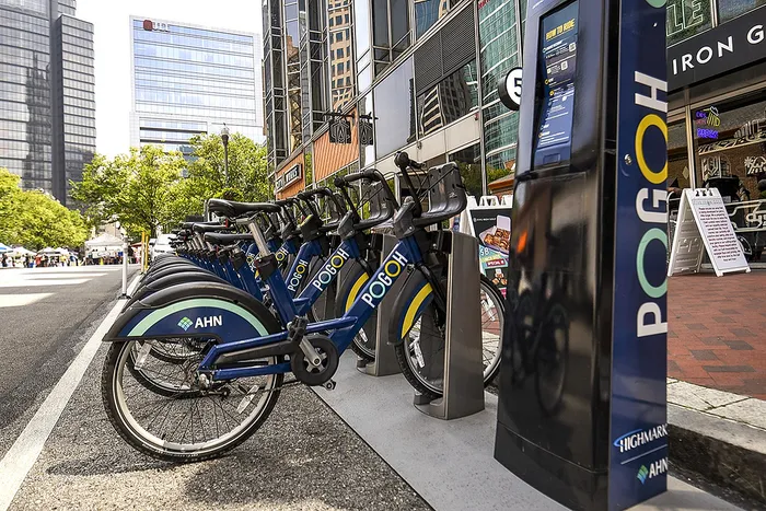 Vibrant city bike station with sleek blue bikes ready for urban exploration.