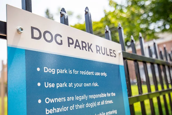 Inviting dog park with secure fencing and clear guidelines, perfect for resident enjoyment and pet safety.