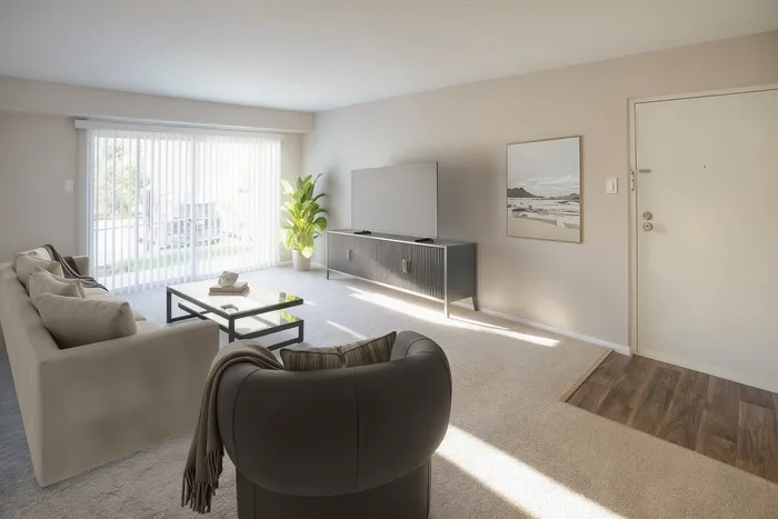 Bright and inviting living room with modern decor, featuring a plush sofa, sleek TV stand, and large windows for ample natural light.