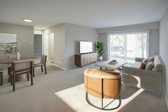 Bright and inviting living room with modern furniture, neutral tones, and large windows overlooking a serene outdoor view.