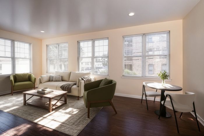 Bright and inviting living room with modern furniture, large windows, and a cozy seating area, perfect for relaxation and entertaining.