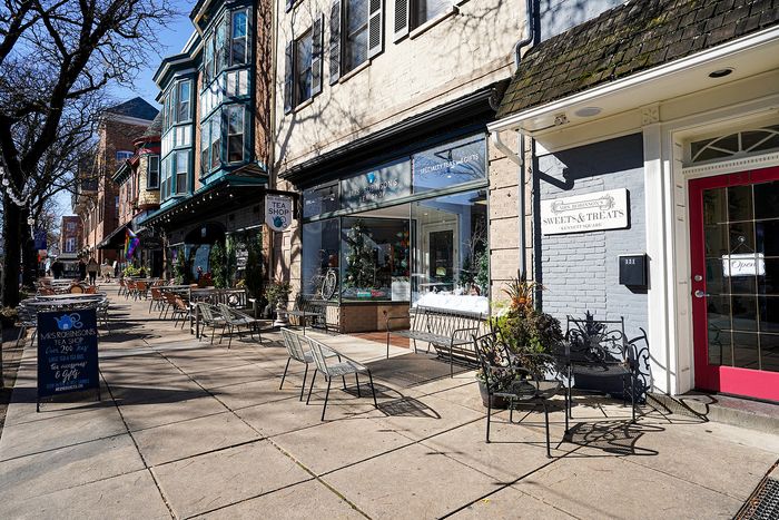 Charming street view with quaint tea shop and outdoor seating, inviting atmosphere for leisurely afternoons.