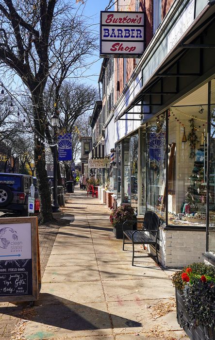Charming small-town street lined with vibrant shops, offering a cozy and welcoming atmosphere for visitors.
