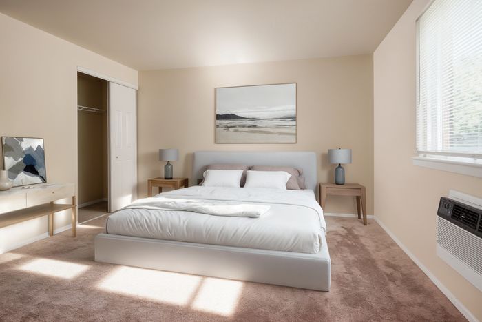 Inviting bedroom with plush carpeting, elegant decor, and large windows providing ample natural light.