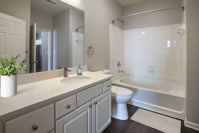 Elegant bathroom with sleek countertops, modern fixtures, and a relaxing bathtub, offering a serene retreat.