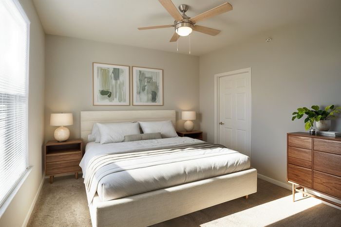 Bright and inviting bedroom with modern decor, featuring a comfortable bed, elegant wooden furniture, and soothing natural light.
