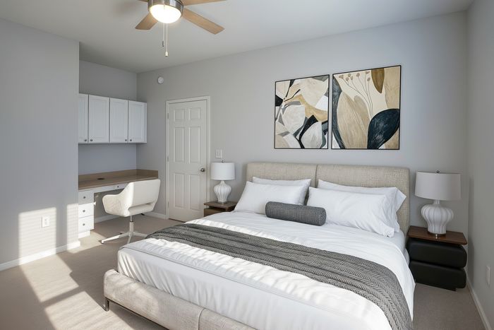 Inviting bedroom with elegant decor, featuring a cozy bed, stylish artwork, and a practical study area with built-in desk.