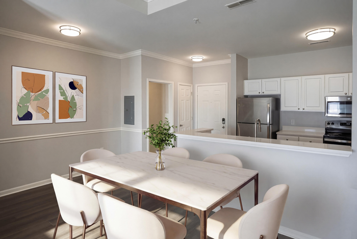 Bright, modern dining area with elegant table and stylish chairs, complemented by a sleek, open kitchen featuring stainless steel appliances.