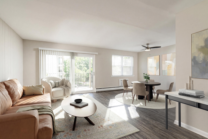 Bright and inviting living room with a modern, open layout featuring soft beige tones, sleek furniture, and ample natural light.