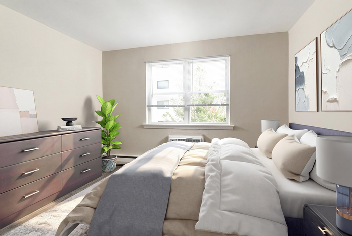 Bright and airy bedroom featuring a plush bed, modern dresser, and vibrant plant beside a sunlit window with elegant artwork on the walls.