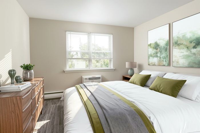 Bright and inviting bedroom with large windows, elegant decor, and plush bedding, perfect for relaxation.