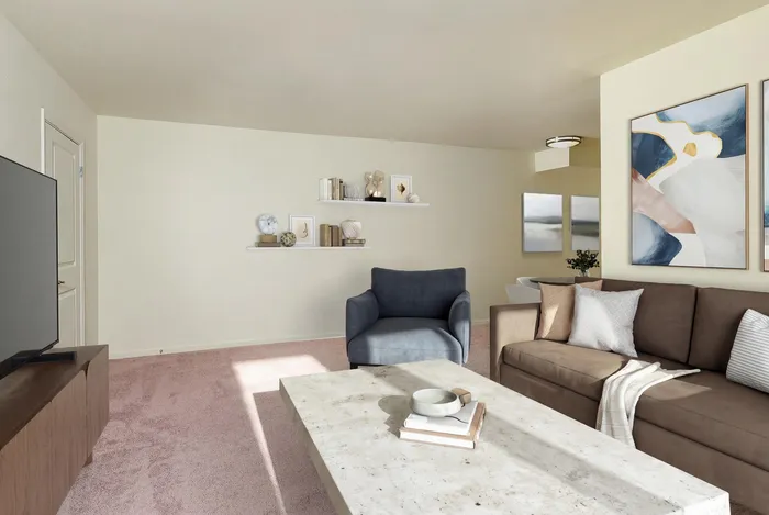 Inviting living room with modern art, cozy seating, and a chic coffee table bathed in natural light.