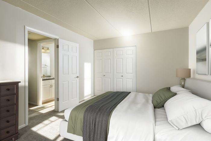 Bright and inviting bedroom with a plush bed, en-suite bathroom, and ample closet space.