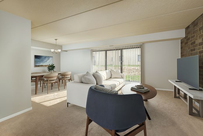 Bright and modern open living space with elegant dining area, cozy seating, and large sliding glass doors for abundant natural light.