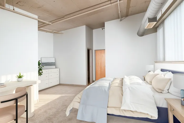 Modern bedroom with stylish furniture, cozy bed, natural light, and calming neutral tones.