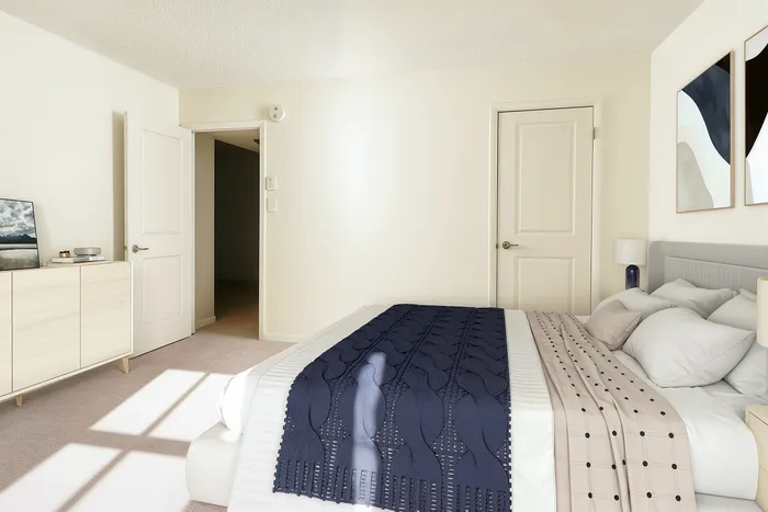Bright and cozy bedroom with stylish decor and elegant furnishings, featuring a modern art piece and soft natural light.