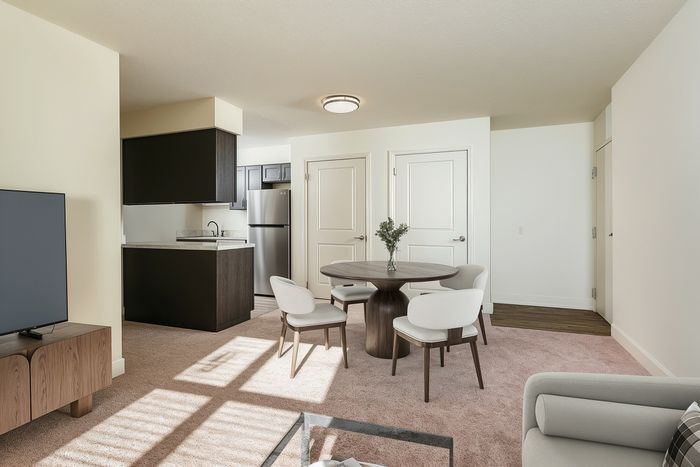 Inviting open-concept living space with a cozy dining area, modern kitchen, and stylish furnishings.