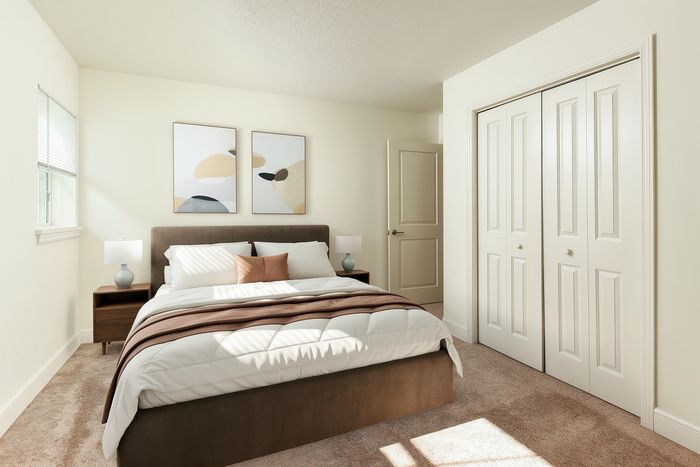 Bright and cozy bedroom featuring a stylish bed with modern artwork and large closet, bathed in natural light.